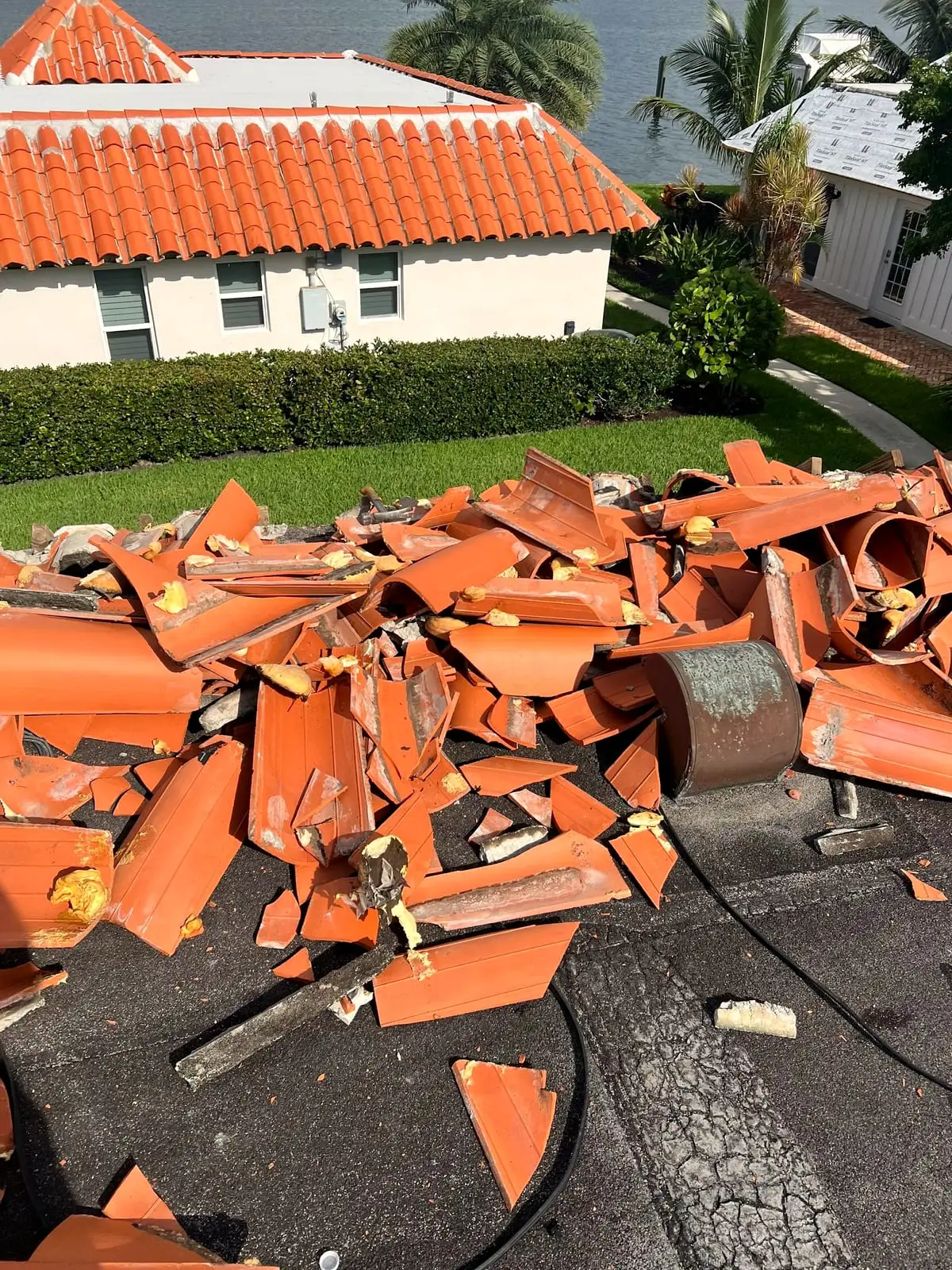 Old clay tile torn off a roof during a replacement, piled on the roof