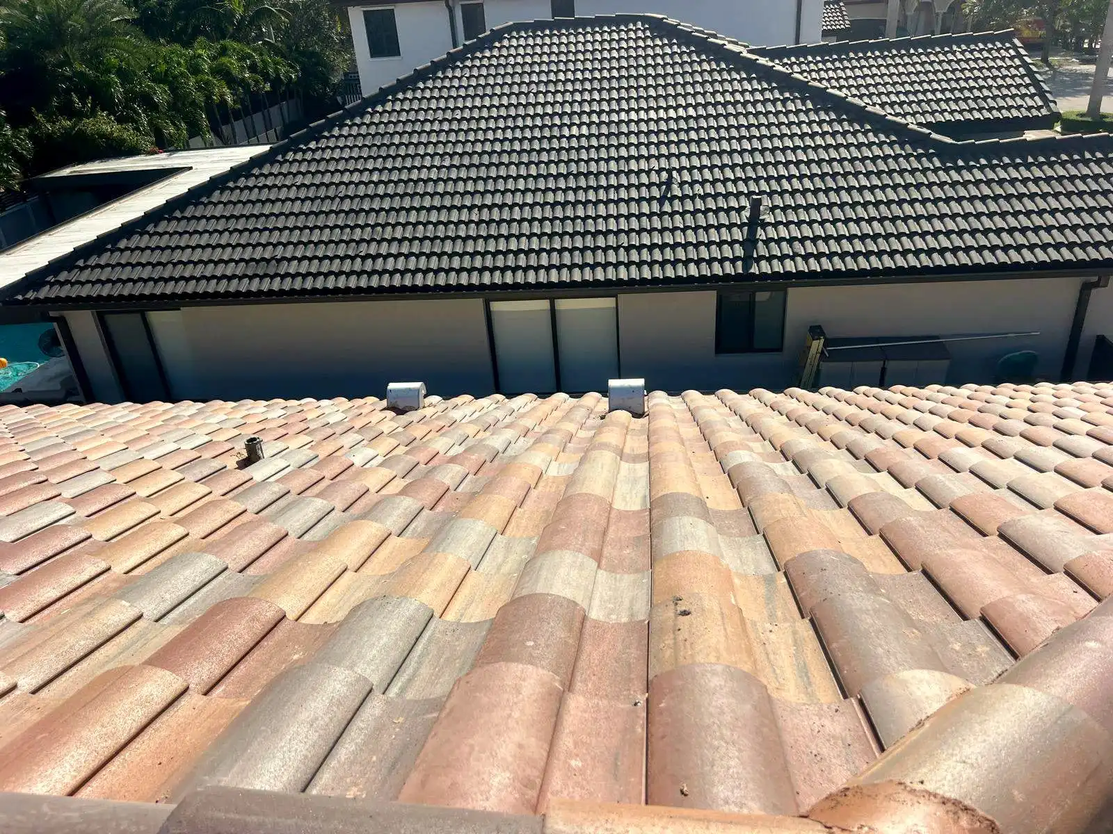 Clay barrel tile roof seen from above, with another tile roof beyond